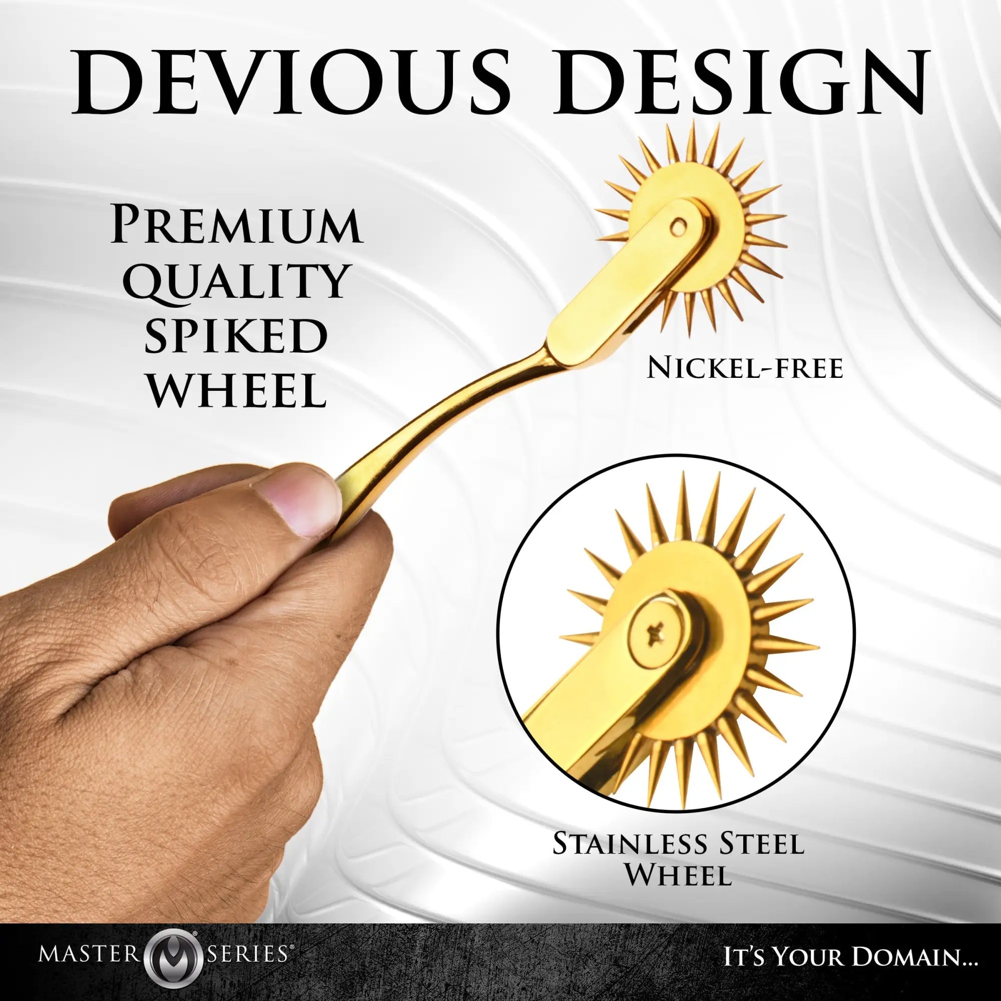A hand holds a gold Master Series Gold Sensation Wartenberg Wheel with a spiked, nickel-free stainless steel tip.