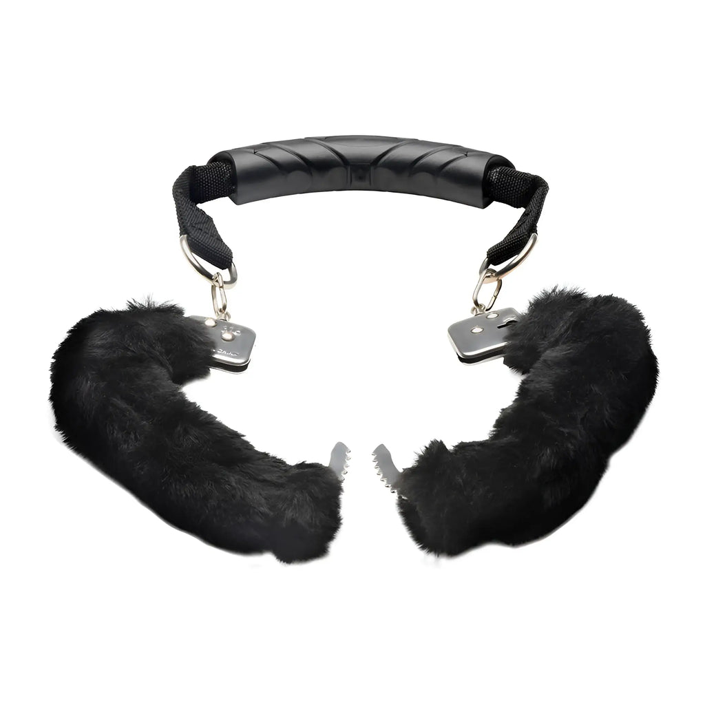 Master Series The Handler: Black furry handcuffs connected by a central ergonomic black plastic handle.