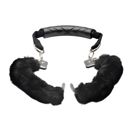 Master Series The Handler: Black furry handcuffs connected by a central ergonomic black plastic handle.