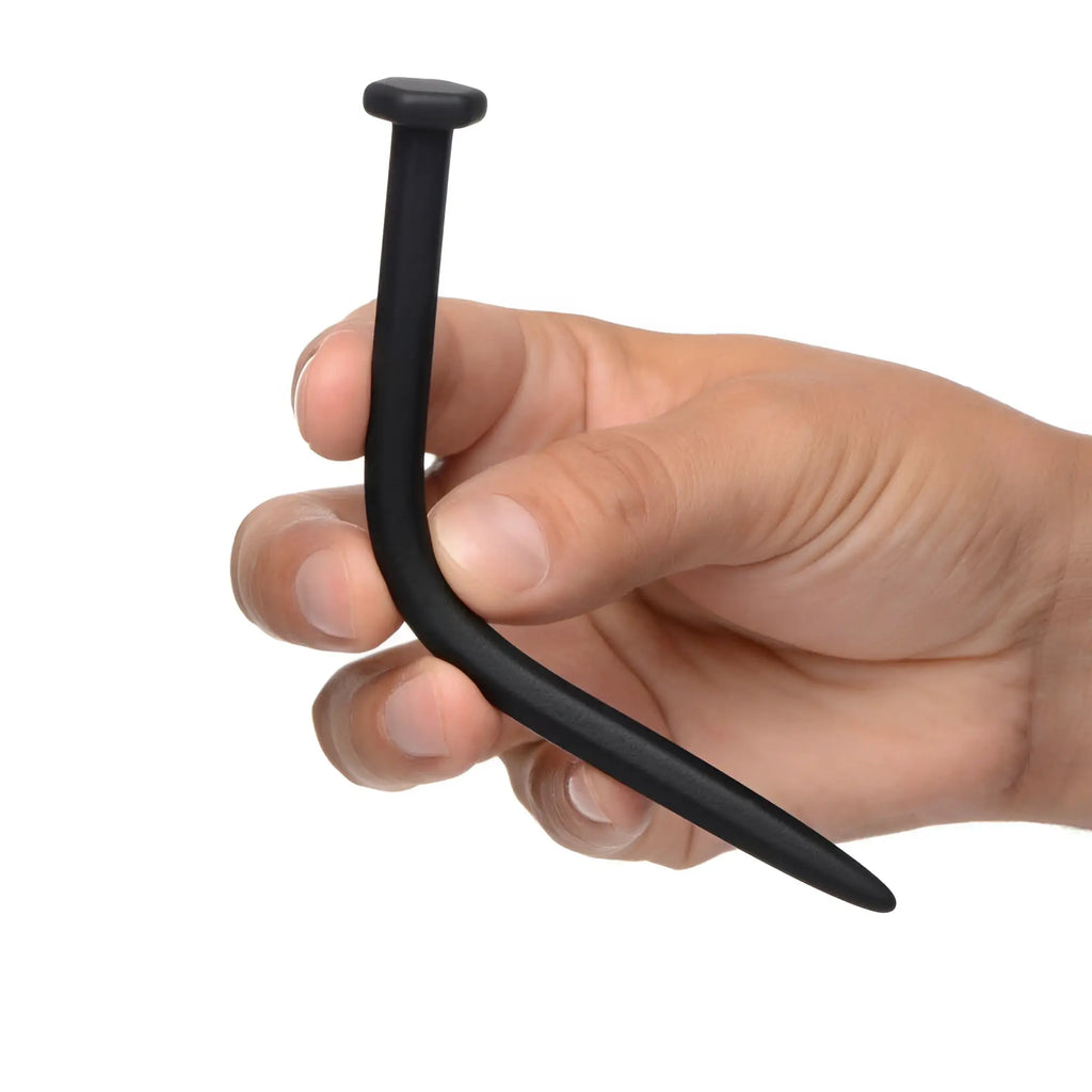 Hand holding a flexible, black silicone Master Series Hardware nail-shaped sound against a white background.