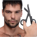 A man holding matte black Master Series Heavy Duty Bondage Scissors with a utilitarian, blunt-tip trauma shear design.