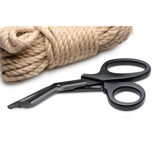 Master Series black heavy-duty bondage scissors with angled blades, resting next to a coil of thick tan jute rope.