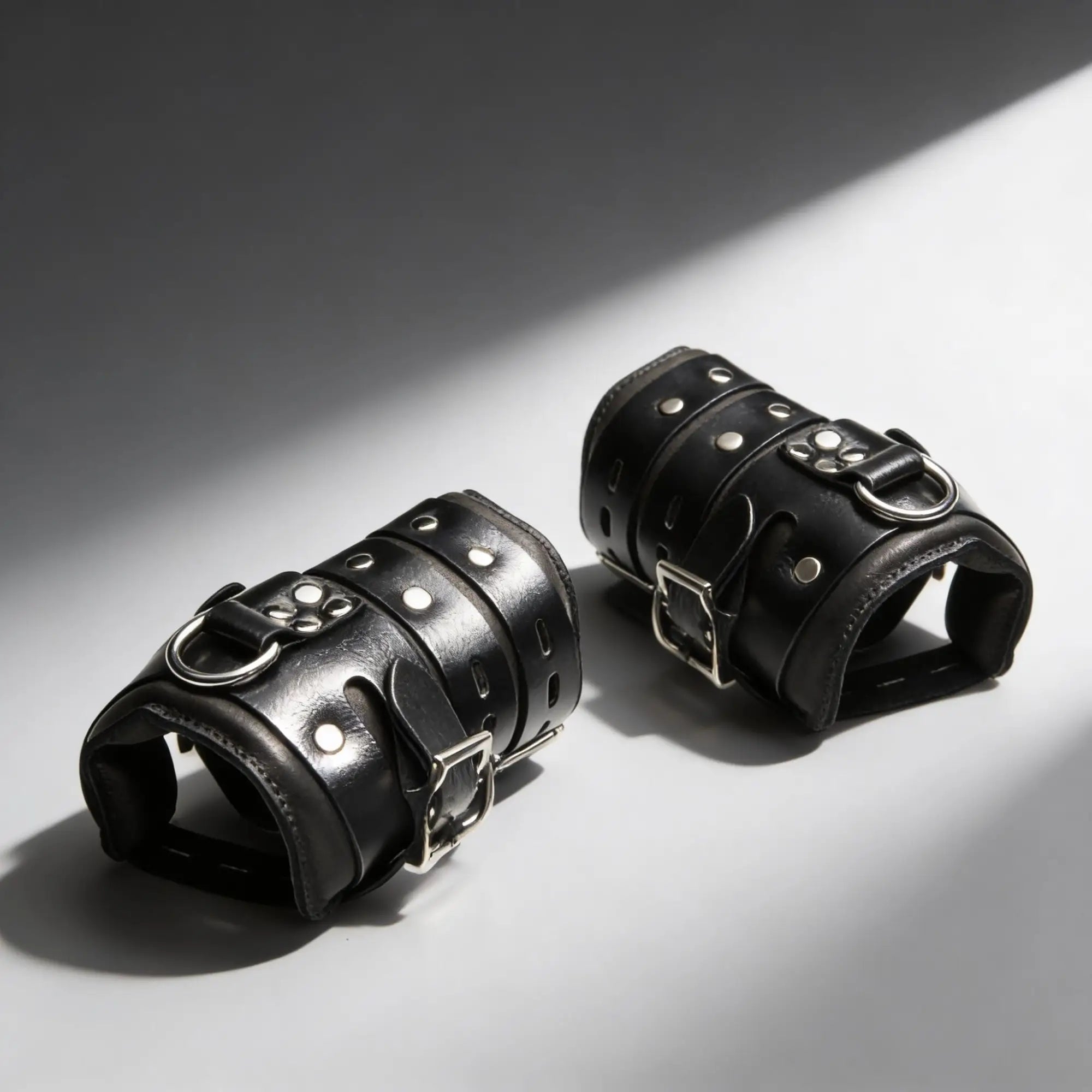Master Series Heavy-Duty Steel Bar Suspension Kit: Two black leather cuffs with silver buckles, studs, and D-rings.