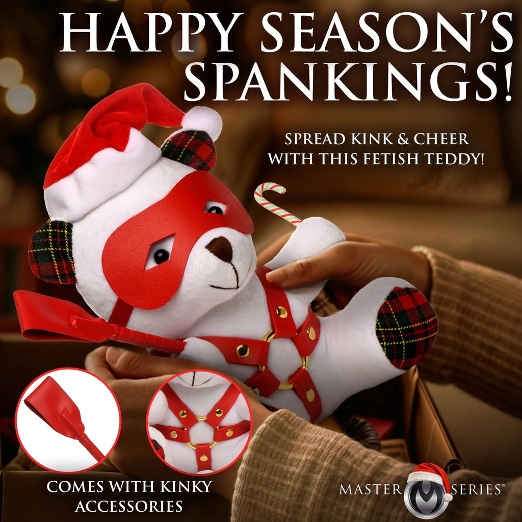 Master Series Holiday Bondage Bear: white plush toy in a red eye mask, plaid ears/paws, red harness, and mini crop.