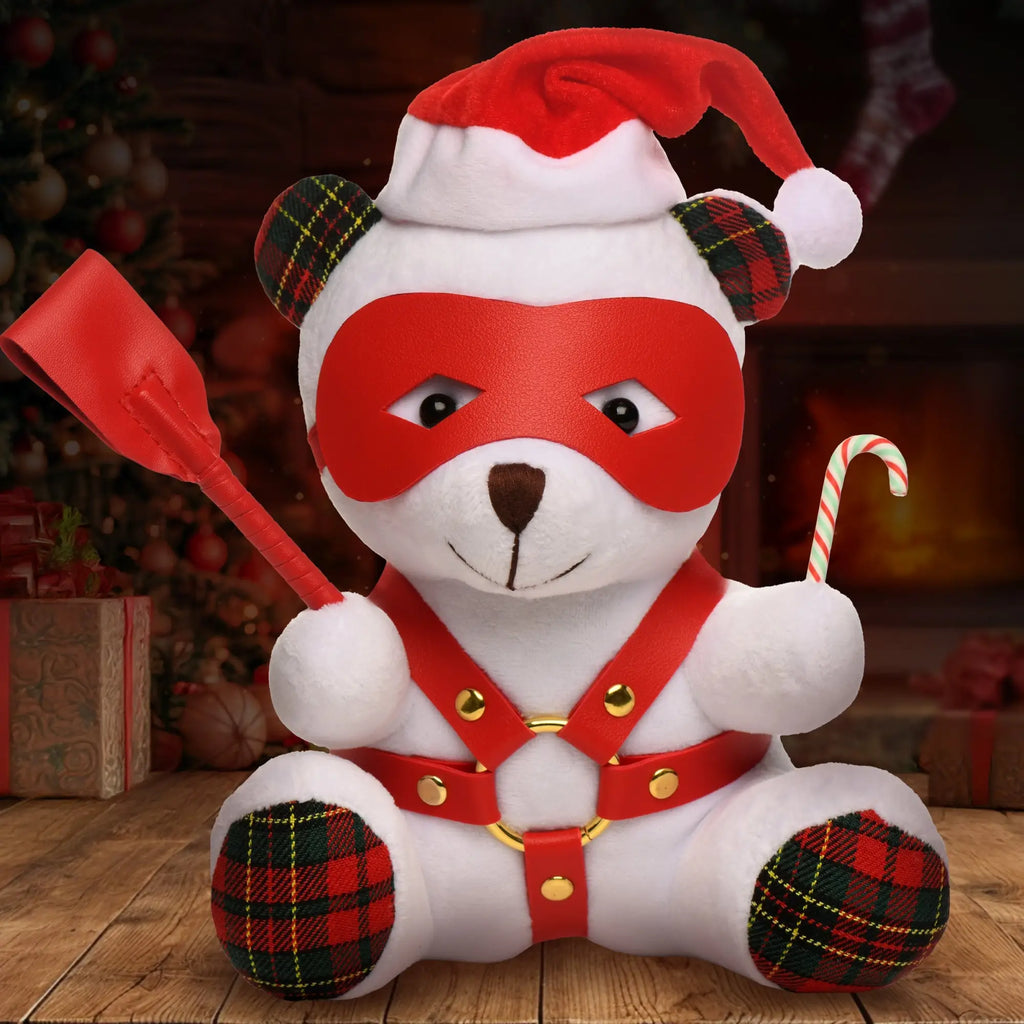 Master Series Holiday Bondage Bear in a Santa hat, red leather mask, chest harness, holding a flogger and candy cane.