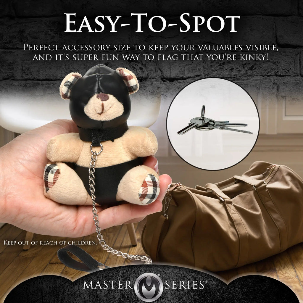 Master Series Hooded Teddy Bear keychain: A tan plush bear in a black hood and harness with a silver chain leash.