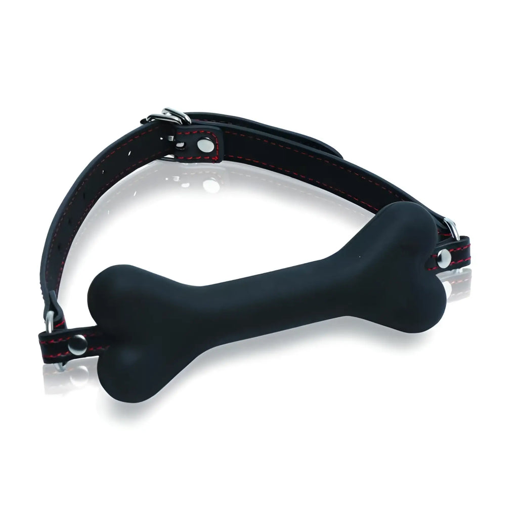 Master Series Hound Adjustable Dog Bone Gag: A black silicone bone mouthpiece on an adjustable black strap with red trim.