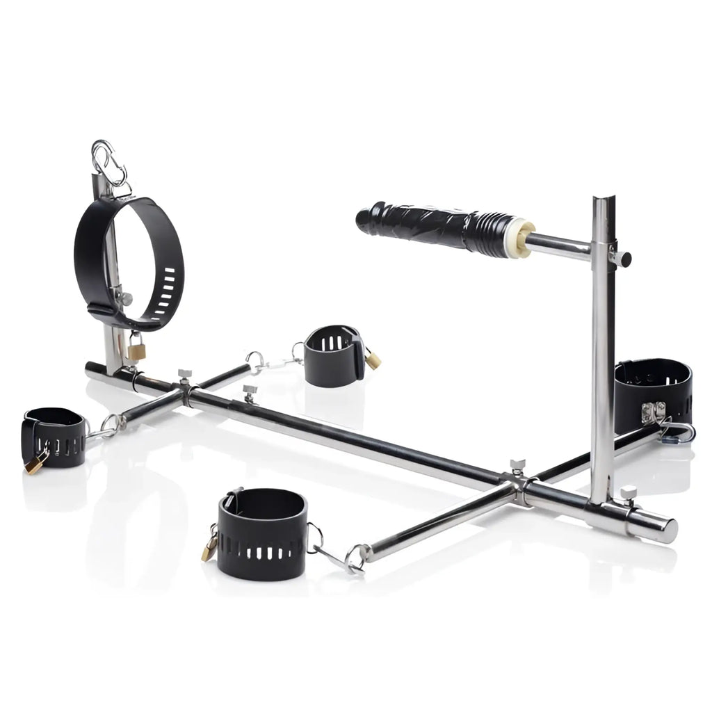 Master Series Imprisoned metal stockade frame with a black dildo and five adjustable black padded cuffs on white.