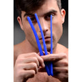 A man holds three smooth, flexible blue silicone Master Series Invasion urethral sound trainers in front of his face.