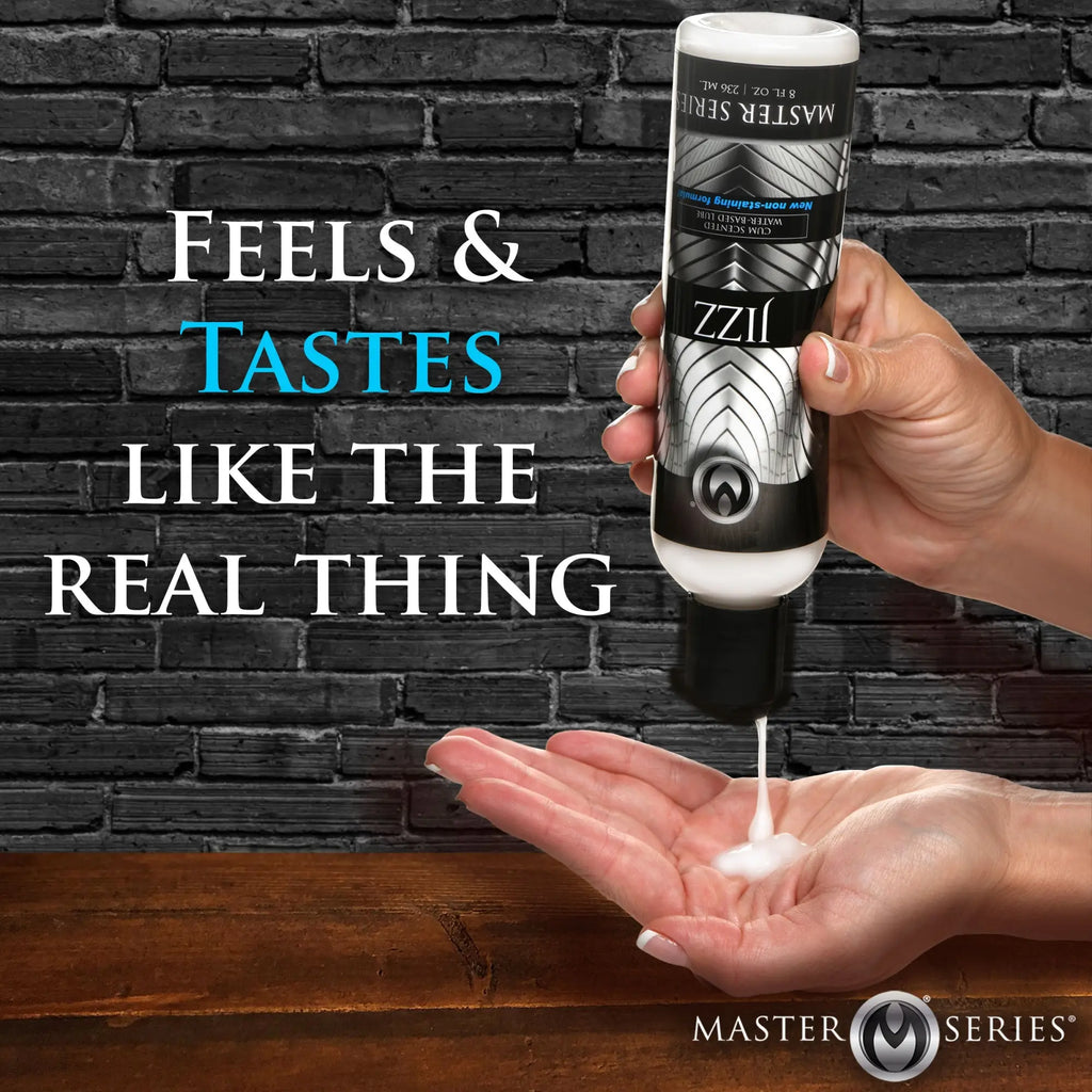 Hand squeezing white liquid from a Master Series Jizz bottle against a brick background. Text reads: Feels like real thing.