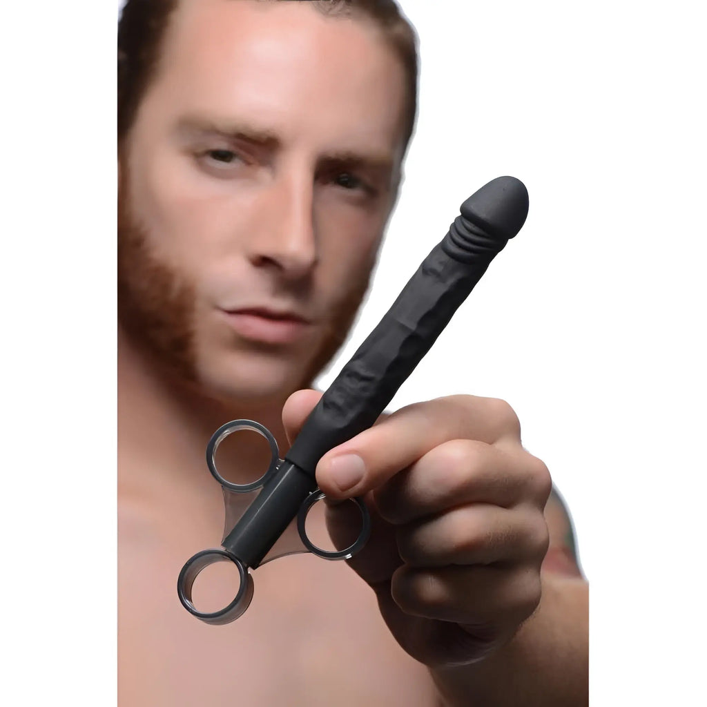 A man holding a black, textured Master Series Jizz Shooter lubricant launcher with a clear finger-grip handle.