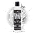 Master Series Jizz Unscented Water-Based Lube bottle in black and silver, centered against a white liquid splash.