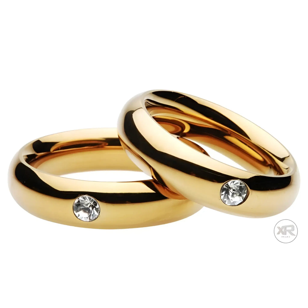 Two gold-tone Master Series Kings Diamond Crown cock rings, each featuring a single clear inset crystal.