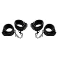 Master Series Kinky Comfort set: four black padded wrist and ankle cuffs connected by short metal chains.