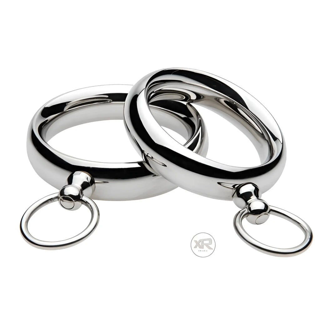 Master Series Lead Me: Two polished, silver-tone stainless steel cock rings with small attached tether loops.