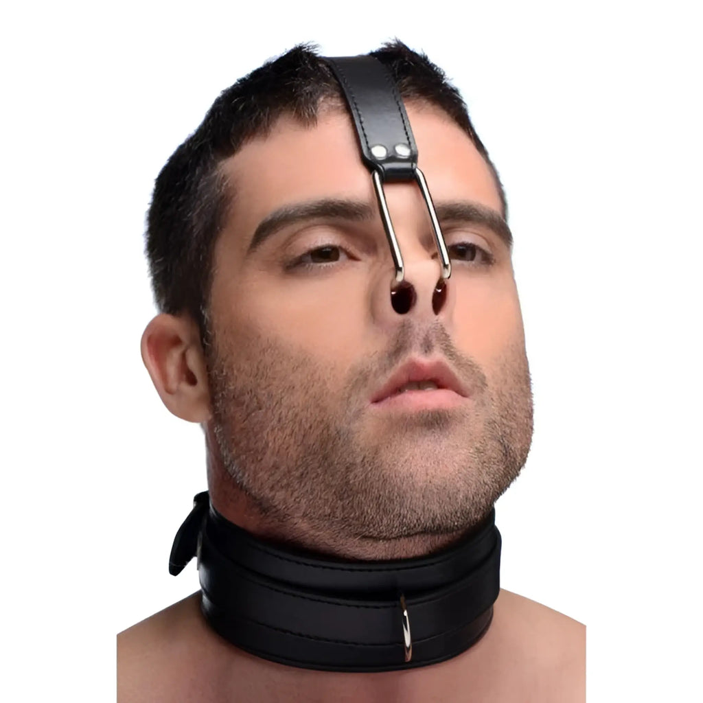 Master Series black leather collar featuring a matching head strap with dual metal nose hooks worn by a man.