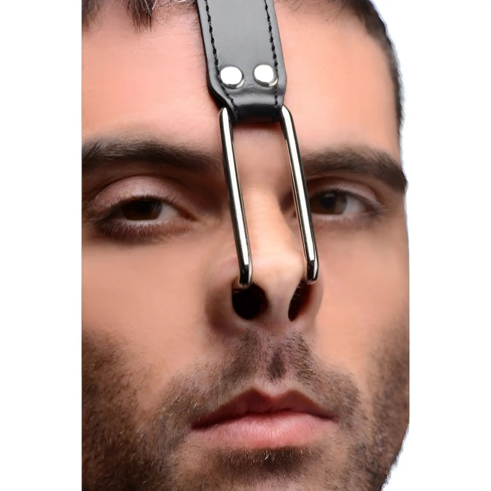 Close-up of a man wearing a black Master Series leather head harness featuring metal nose hooks.