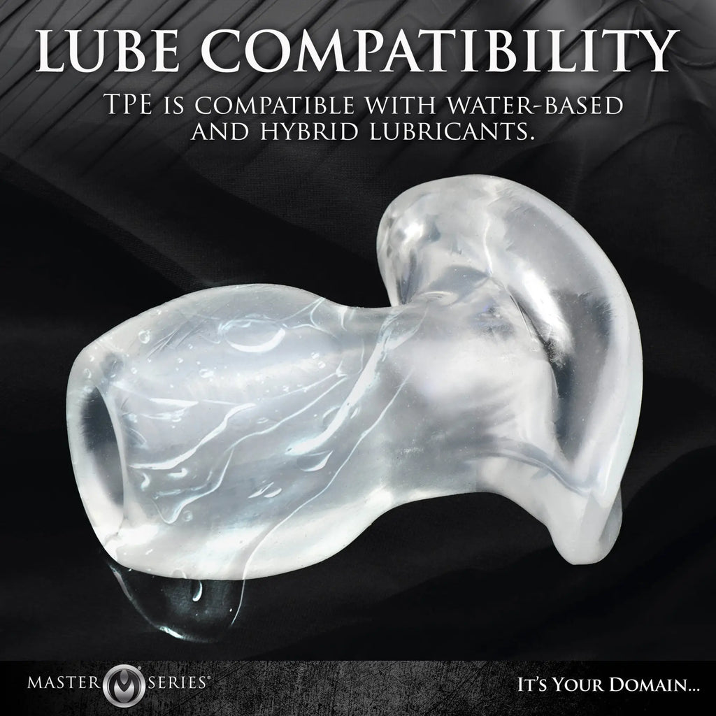 Master Series Light-Tunnel Anal Dilator: A clear, translucent TPE flared-base plug on a black background.