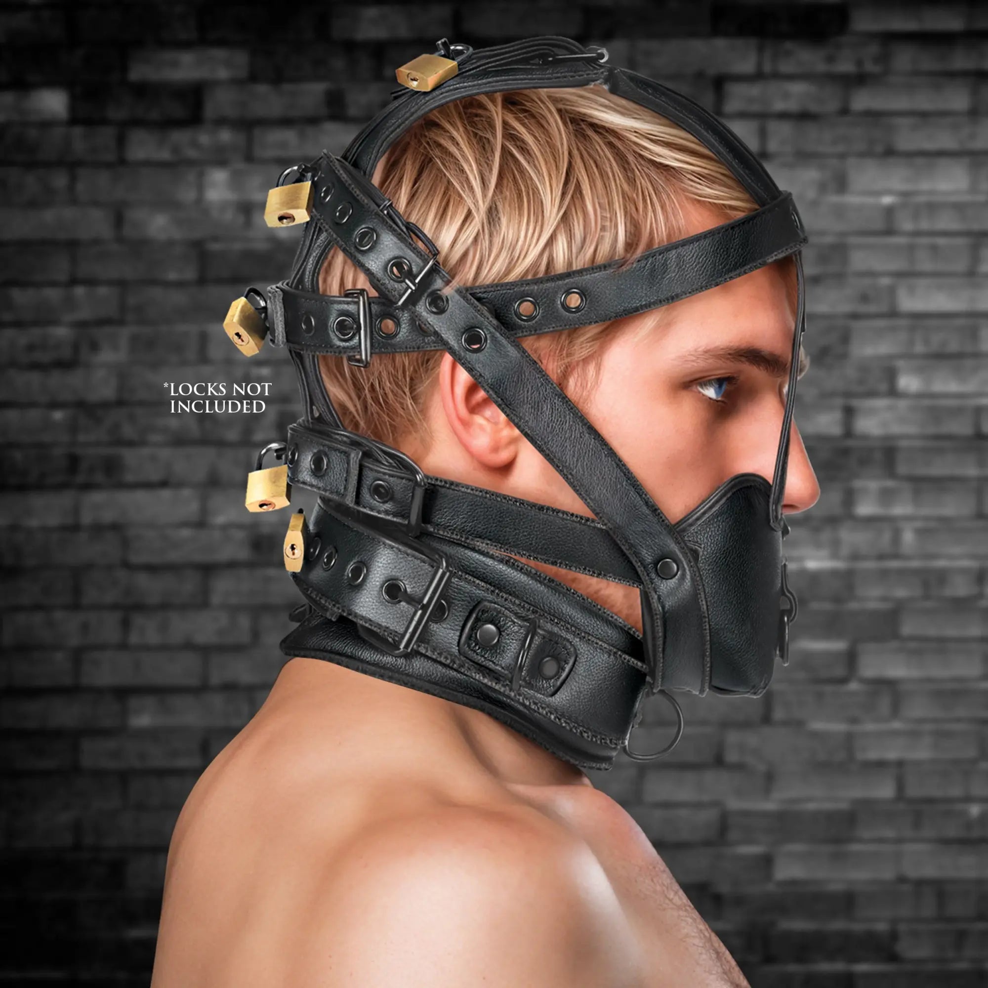 Master Series black leather lockable head harness with an integrated muzzle, worn by a man against a brick background.