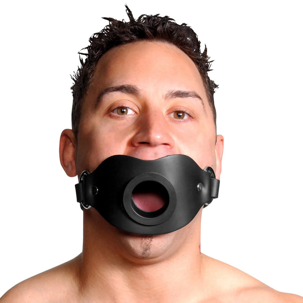 Master Series Locking Open Mouth Gag: A black, contoured silicone face harness holding the mouth in an open position.