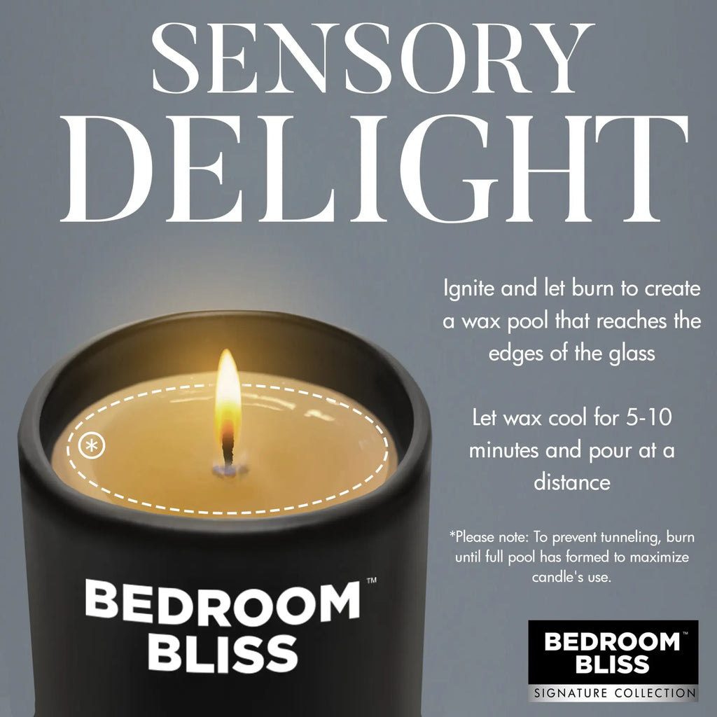 Master Series Lover's Vanilla Massage Candle in a black jar with a burning wick and instructions on use.