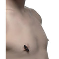 Master Series Mag-Points: A person wearing sleek, glossy black magnetic clamps on their nipple.