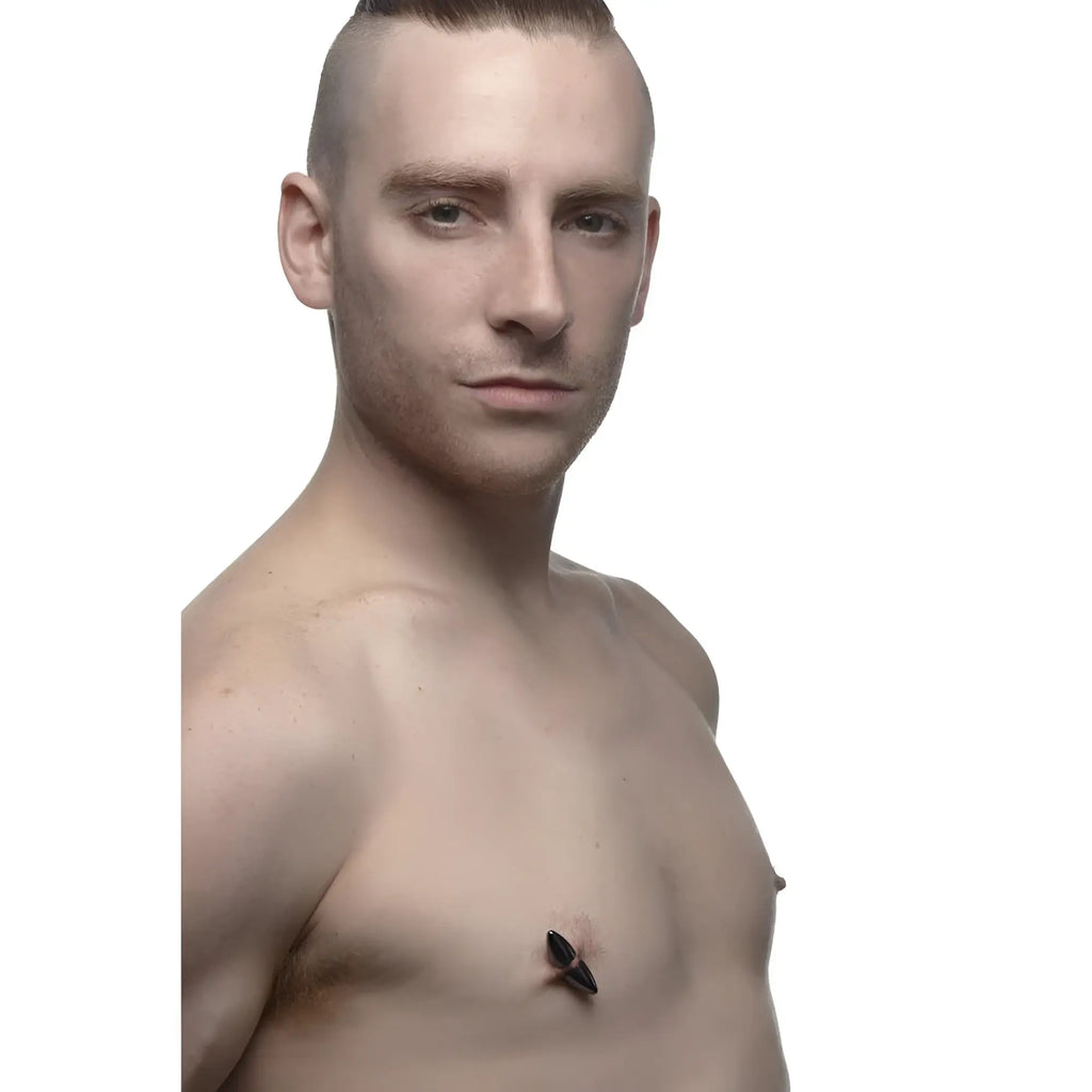 Master Series Mag-Points: A man wears a sleek, black, pointed magnetic clamp on his nipple against a white background.
