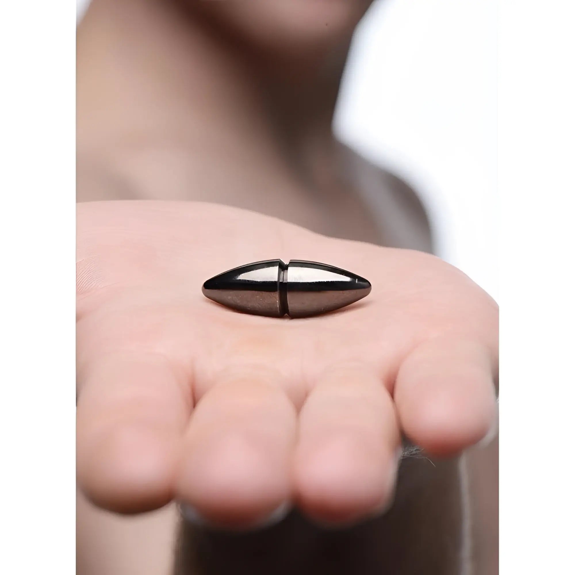 Master Series Mag-Points Magnetic Clamps: a smooth, black, torpedo-shaped metallic clasp resting in an open palm.
