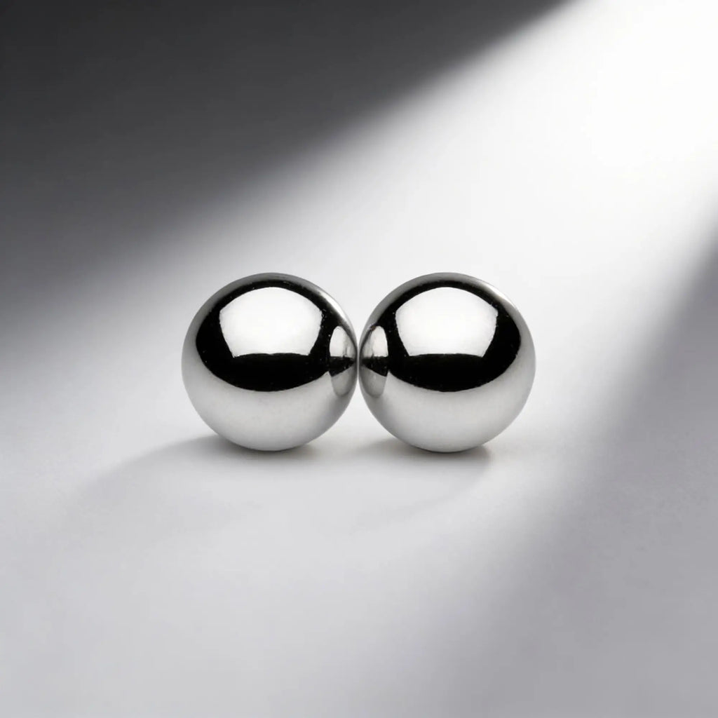 Two polished, chrome-colored Master Series Magnus Mighty Magnetic Orbs sitting side-by-side on a light gray surface.