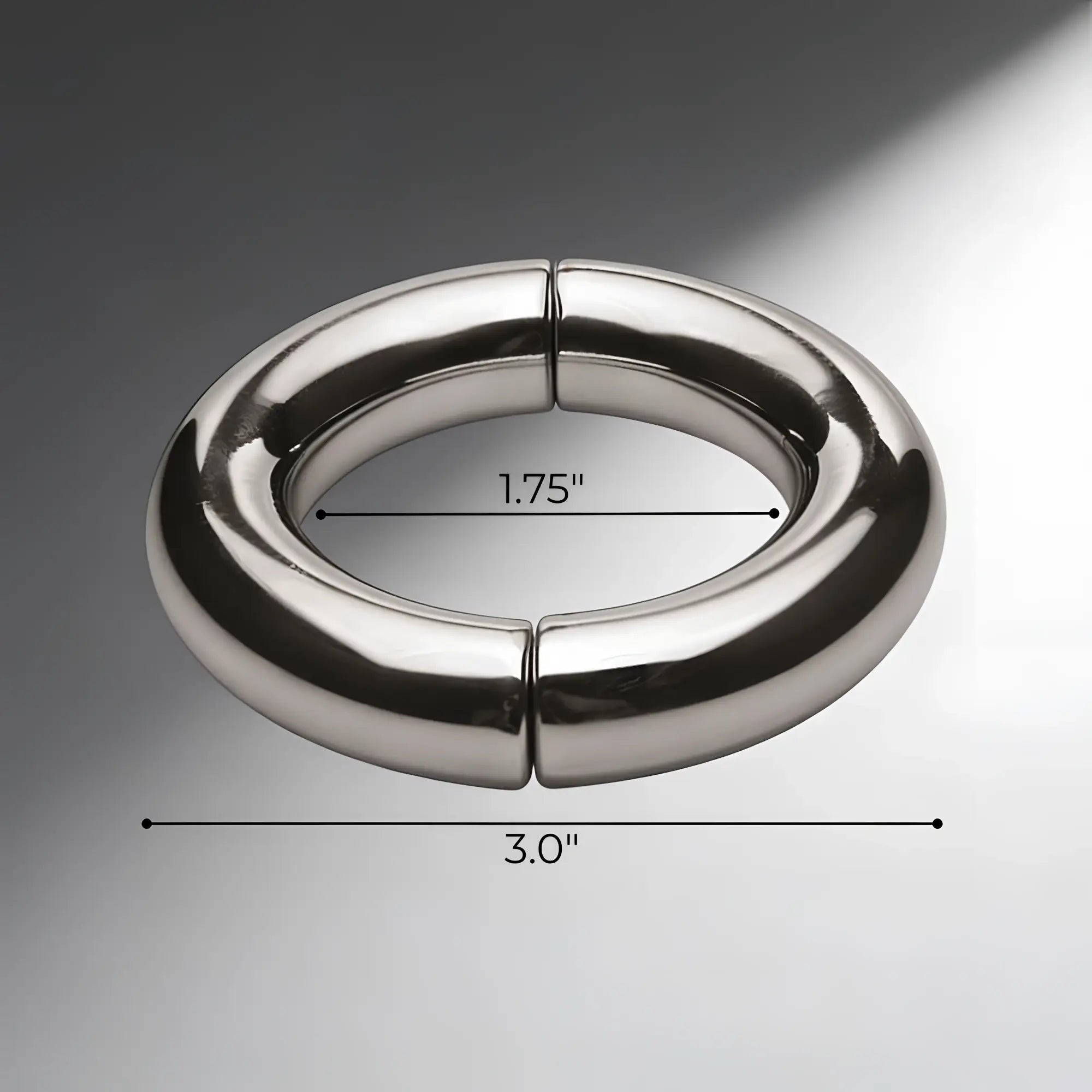 Master Series Mega Magnetize stainless steel cock ring. Polished silver, two-piece magnetic design, 1.75" by 3" scale.