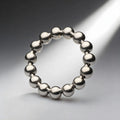 Master Series Meridian stainless steel ball-bearing cock ring, featuring a polished silver metallic bead-link design.