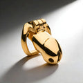 Master Series Midas 18K gold-plated locking chastity cage in a smooth, polished, minimalist metal design.