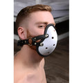 Master Series Musk Athletic Cup Muzzle: A man wearing a white, vented, cup-style mask with black leather straps.