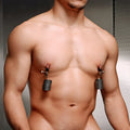 Master Series nipple clips with stacks of gray magnetic weights attached to a man’s chest.