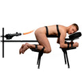 Master Series Obedience Chair with integrated black sex machine, featuring a man secured by straps on black cushions.