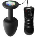 Master Series The Paragon Gem vibrating black silicone butt plug with a multicolored crystal top and wired remote.