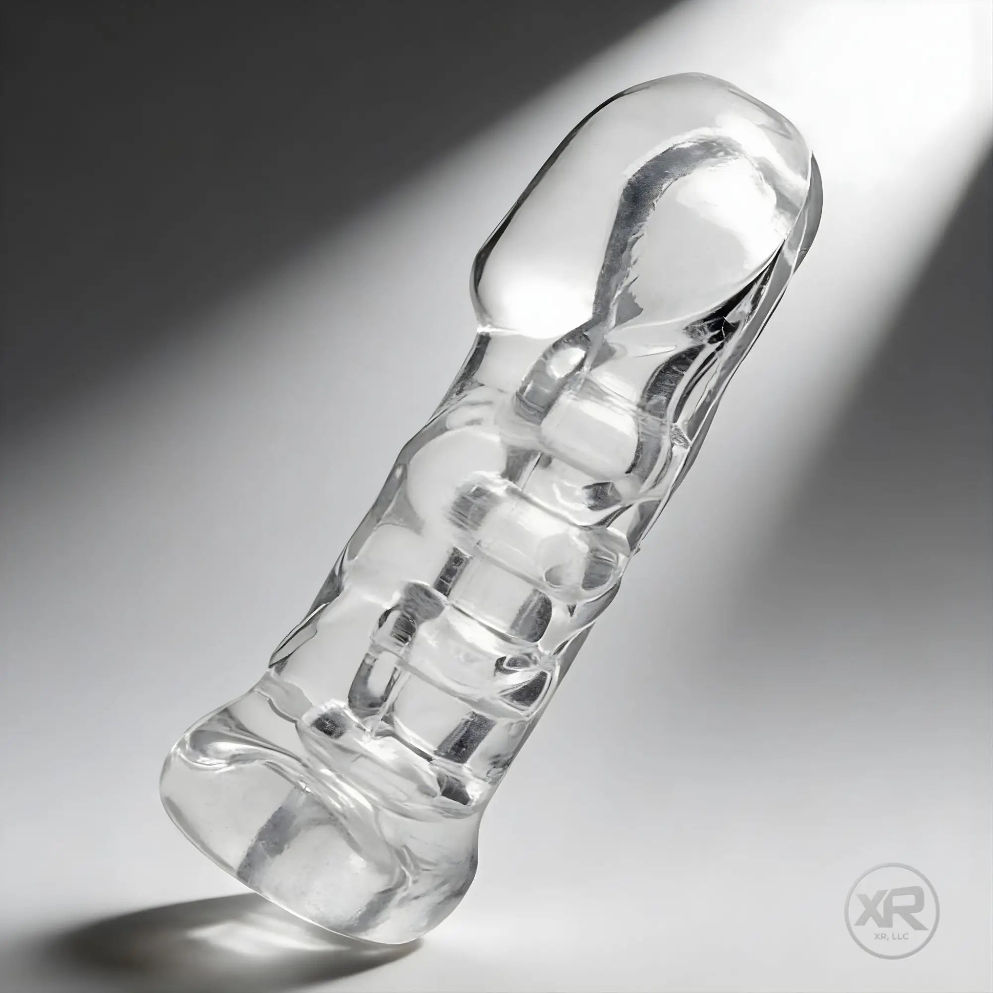 Master Series Penetrator, a clear, textured, cylindrical silicone girth-enhancing device and stroker against gray.