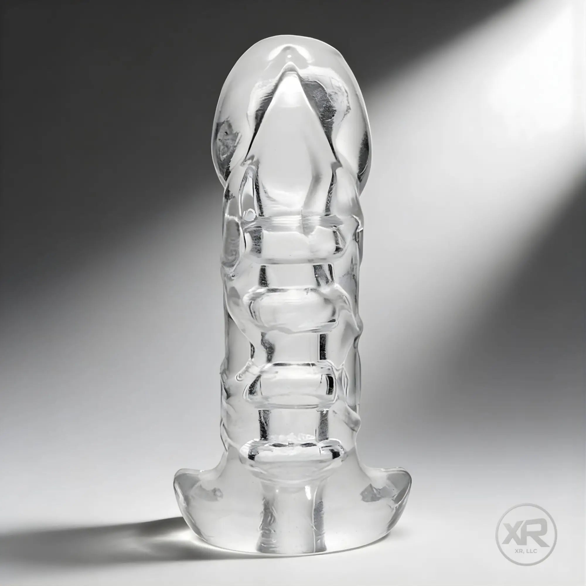Master Series Penetrator, a clear, phallic-shaped girth-enhancing stroker standing upright against a grey background.