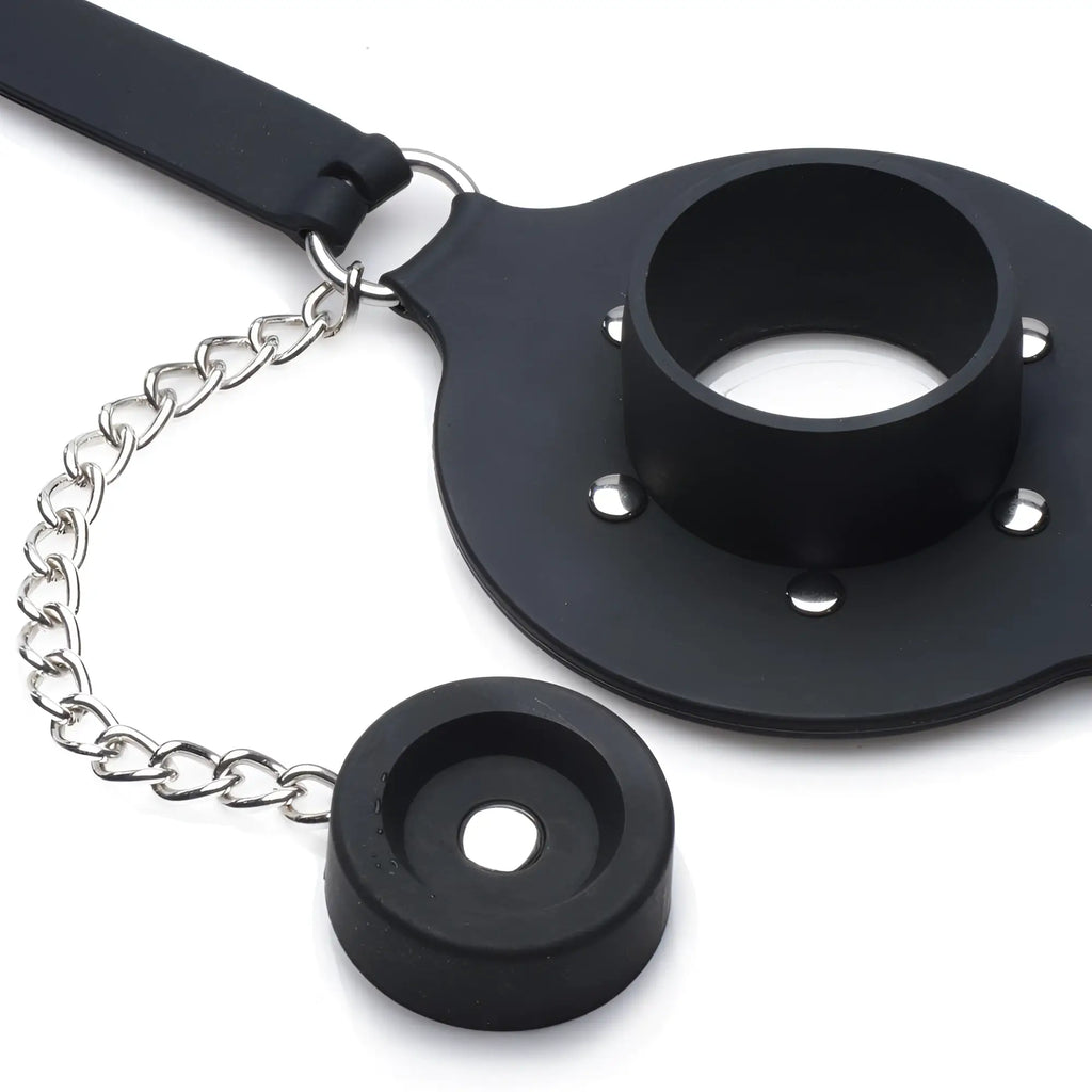 Master Series Pie Hole black silicone feeding gag with a metal chain, ring, and circular mouthpiece on a white background.