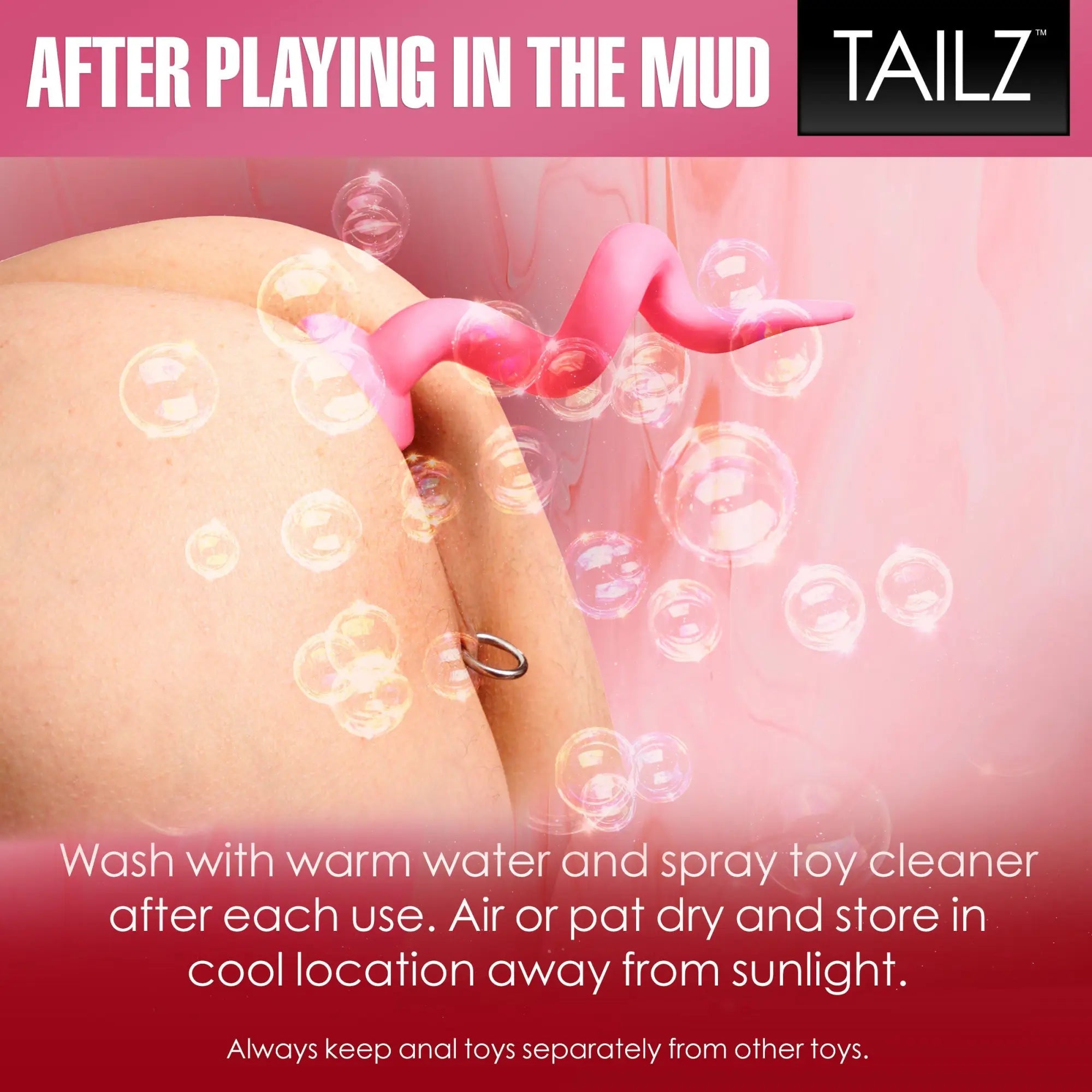 Master Series pink pig tail butt plug, a curved, playful silicone tail accessory in use, surrounded by soap bubbles.