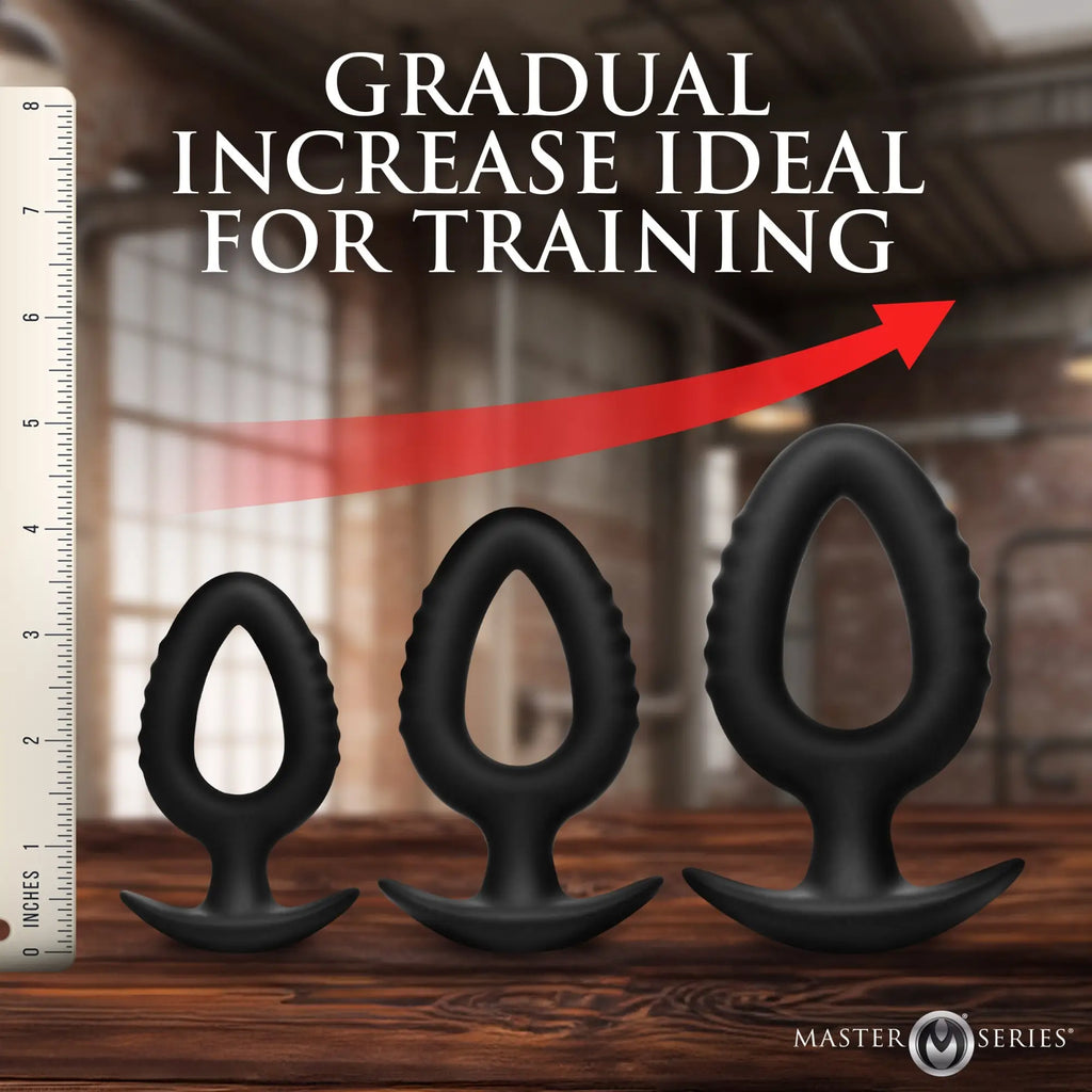 Master Series Pop Plugs: 3-piece set of black, hollow silicone anal trainers shown in increasing sizes next to a ruler.