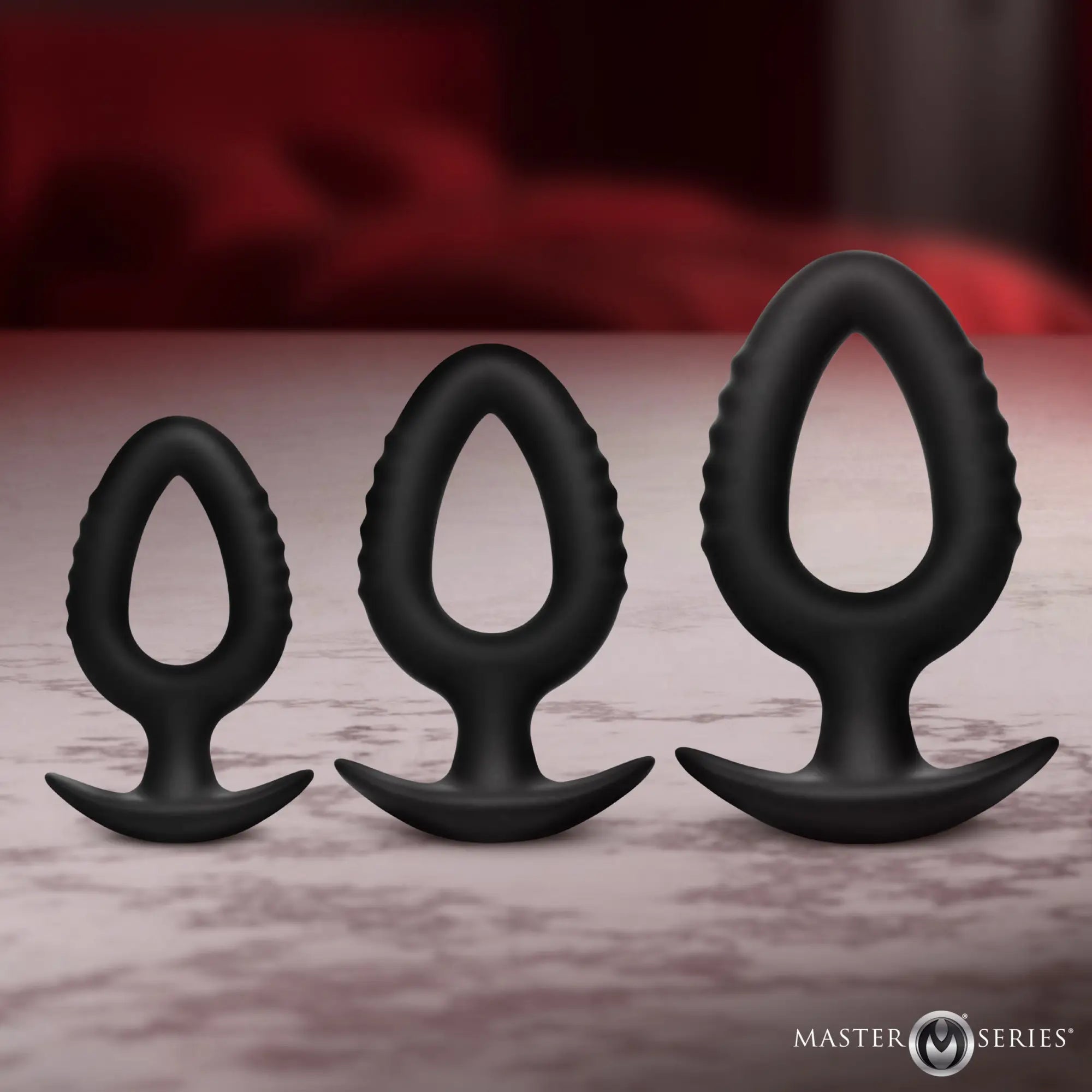 Master Series Pop Plugs: 3-piece set of black, hollow silicone anal trainers with teardrop shapes and flared bases.