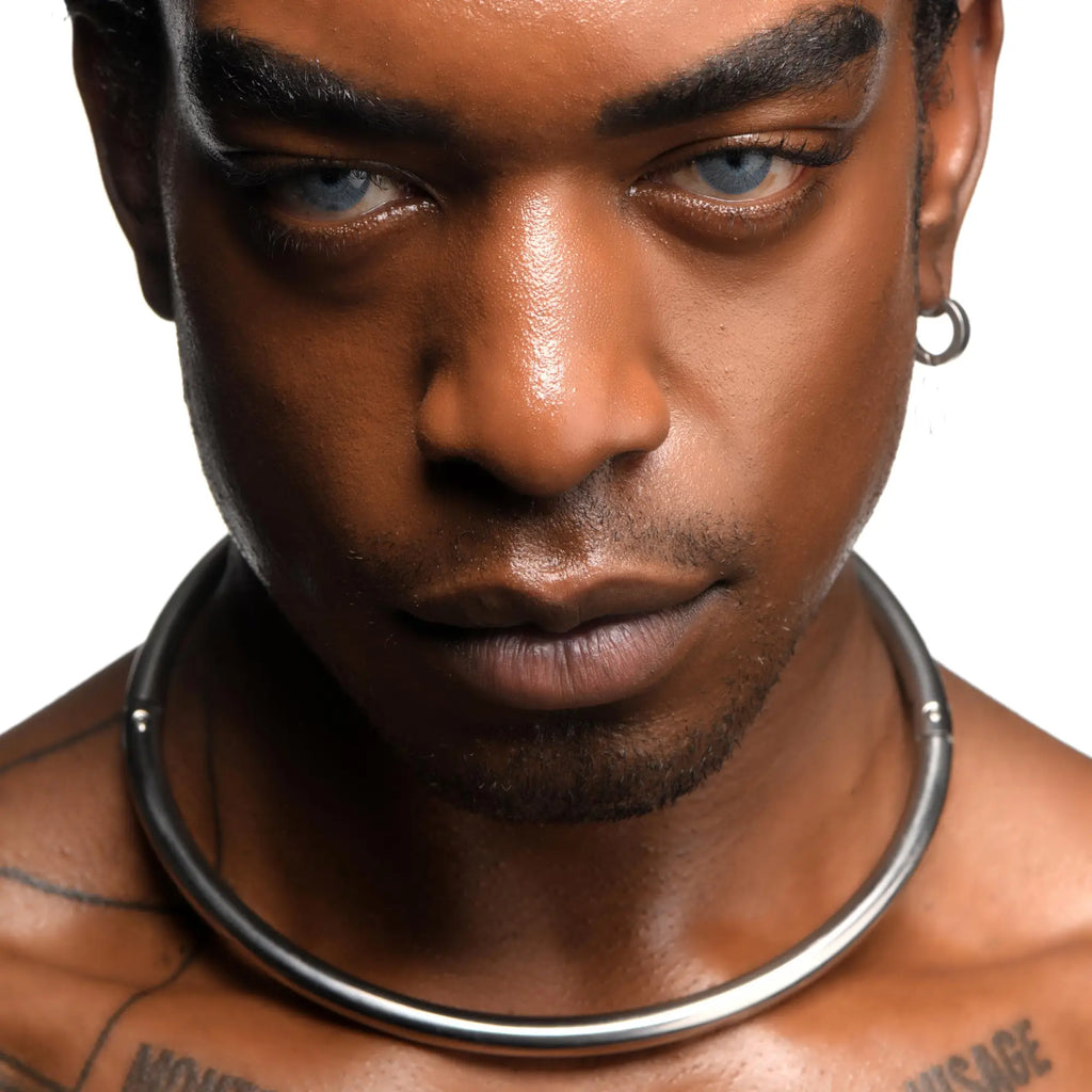Close-up of a man wearing a smooth, silver-toned Master Series Possession Stainless Steel Locking Collar.
