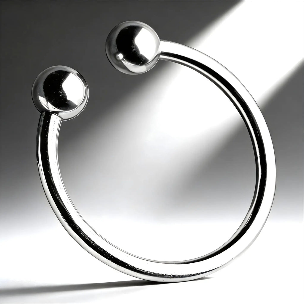 Master Series Pressure Point Beaded Glans Ring: a smooth, polished chrome, C-shaped metal ring with rounded ball ends.