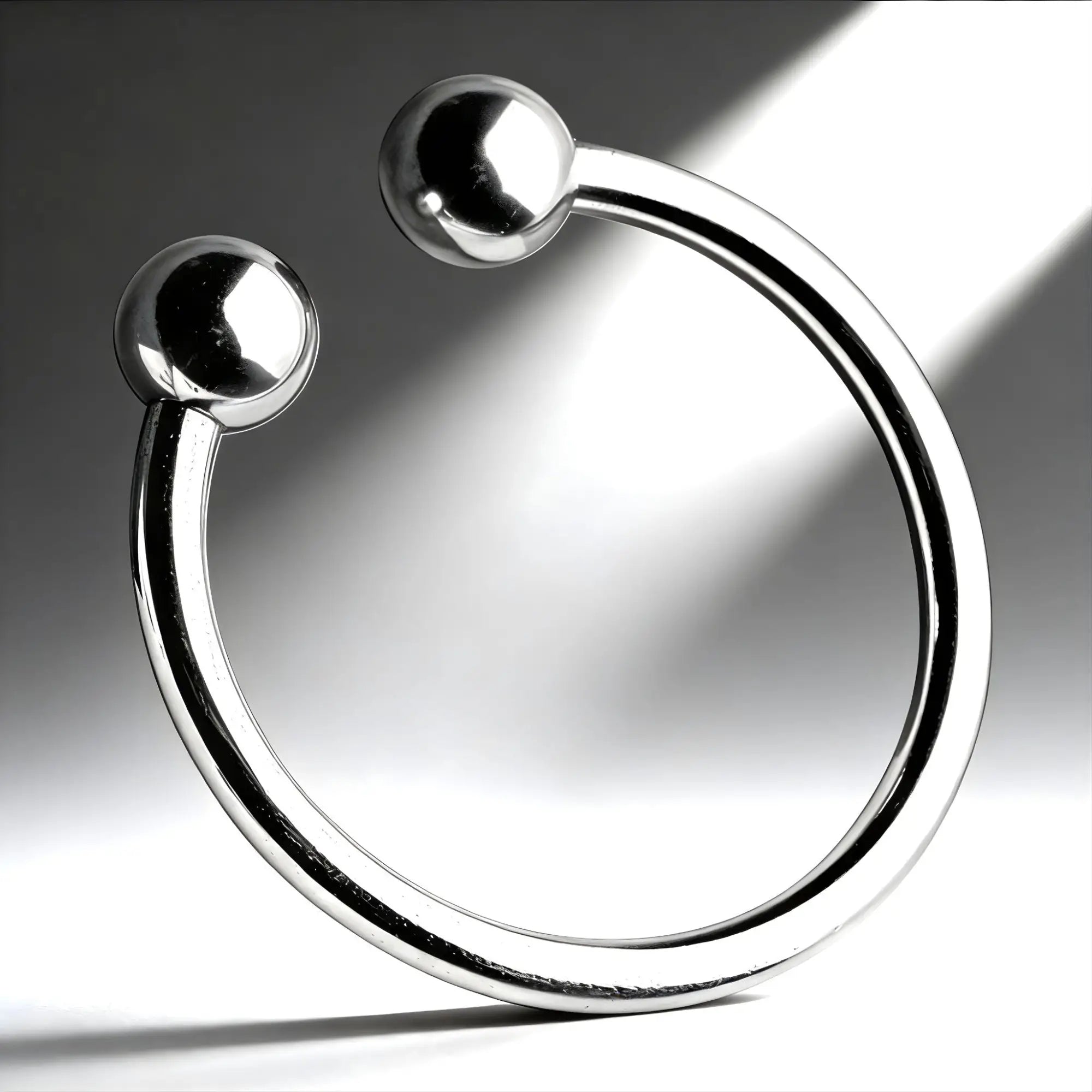 Master Series Pressure Point Beaded Glans Ring: a smooth, polished chrome, C-shaped metal ring with rounded ball ends.