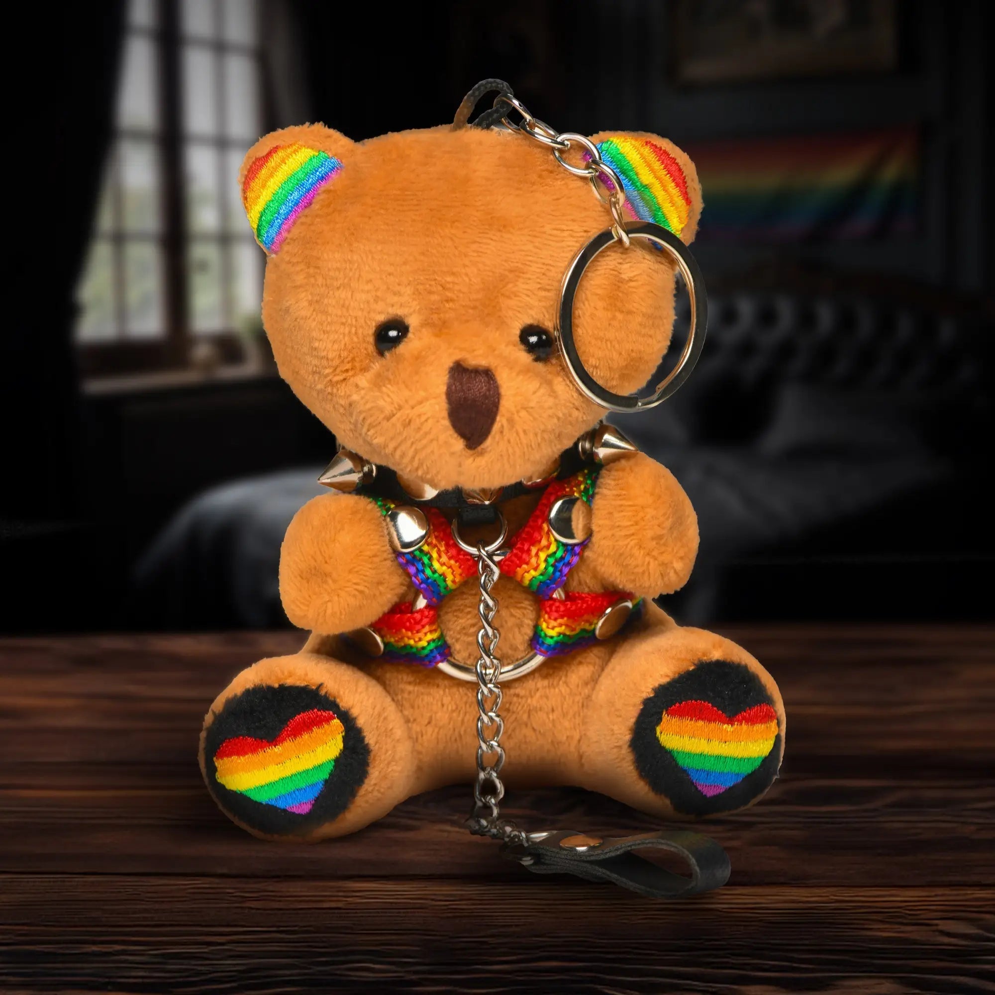 Master Series Pride Bear: A tan plush bear with a rainbow-accented harness, spiked collar, and rainbow heart paw pads.