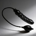 Black Master Series Primal inflatable dildo with realistic texture and attached air pump bulb on a gray background.