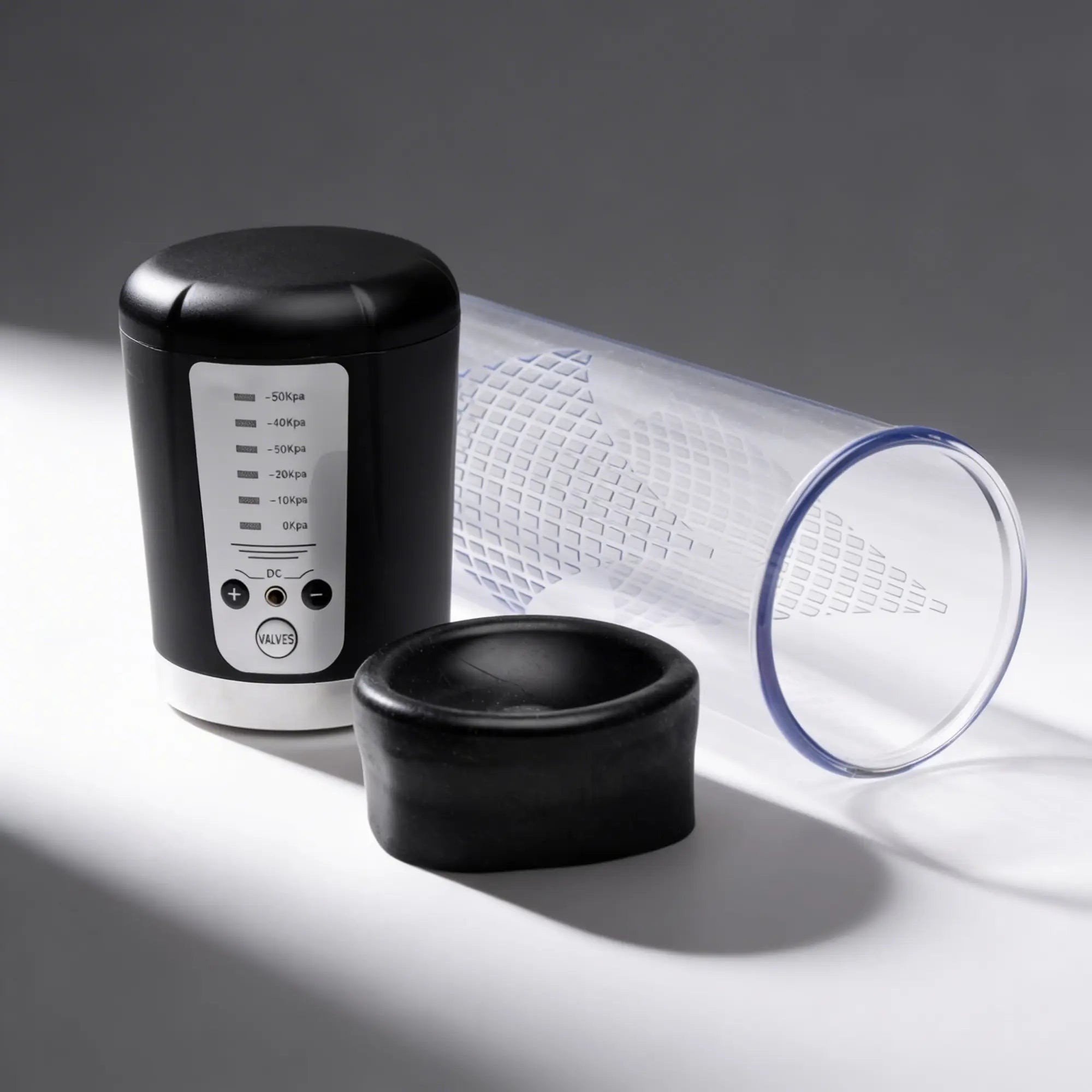Master Series Pumping Master: black electric suction unit with pressure settings, a clear tube, and a black silicone ring.