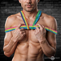 Master Series Rainbow Rope: A shirtless man holds a vibrant, multi-colored braided rope tied around his chest.