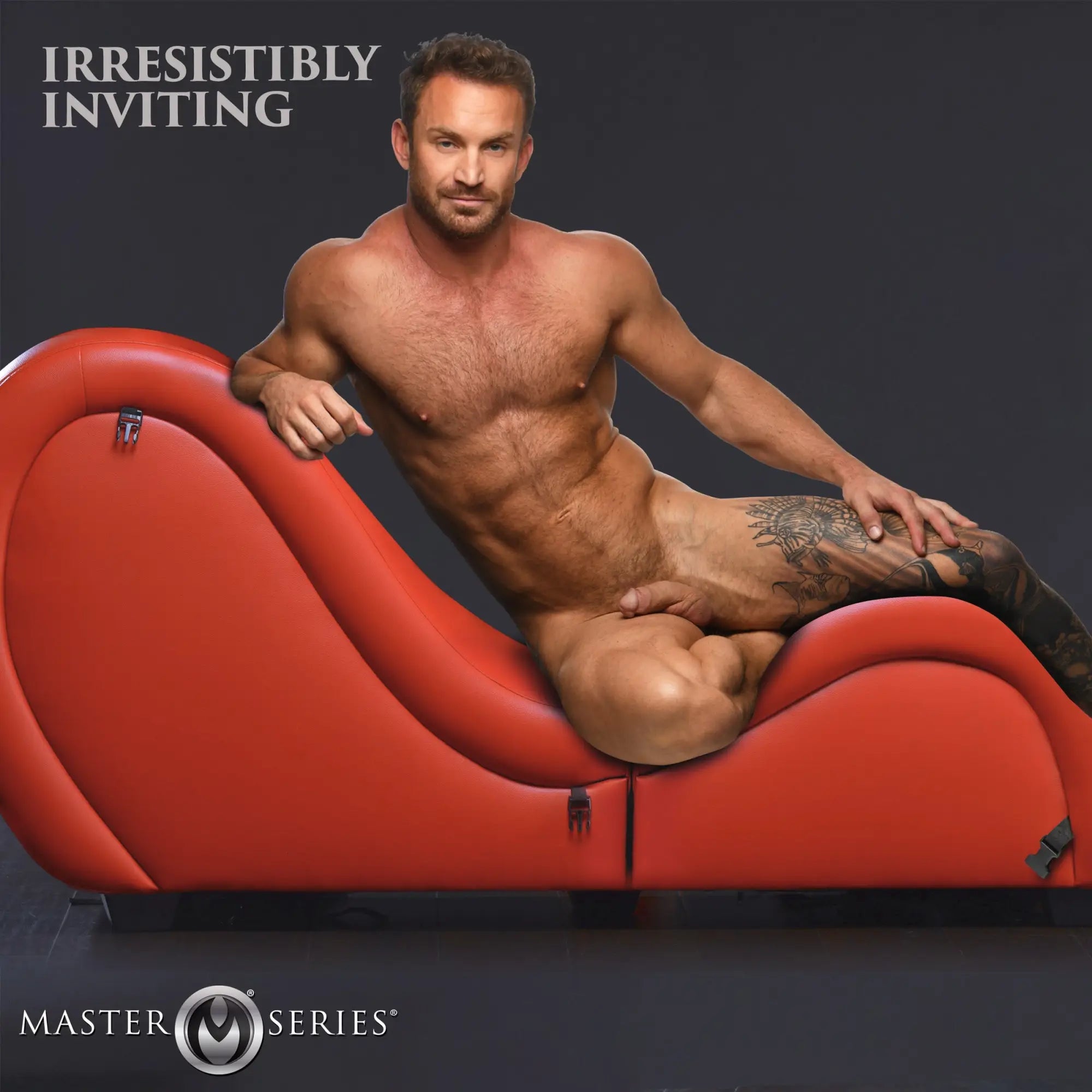 Master Series red detachable kinky couch chaise with a nude tattooed man posing on it against a dark background.